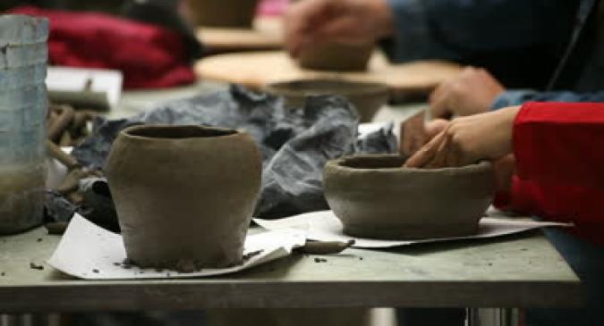 stock_footage_pottery_class_workshop_clay_shaping_on_potter_s_wheel.jpg